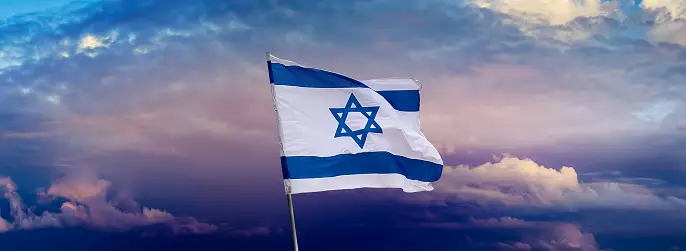 Waving Israel flag on the cloud sky background